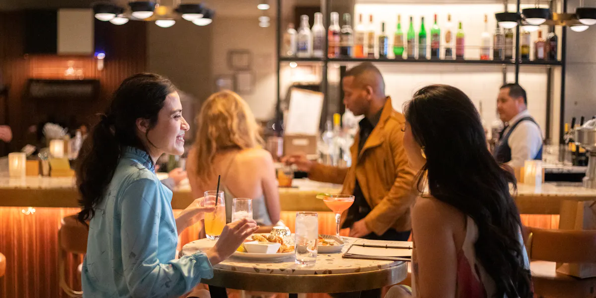 a group of people sitting at a table in a restaurant