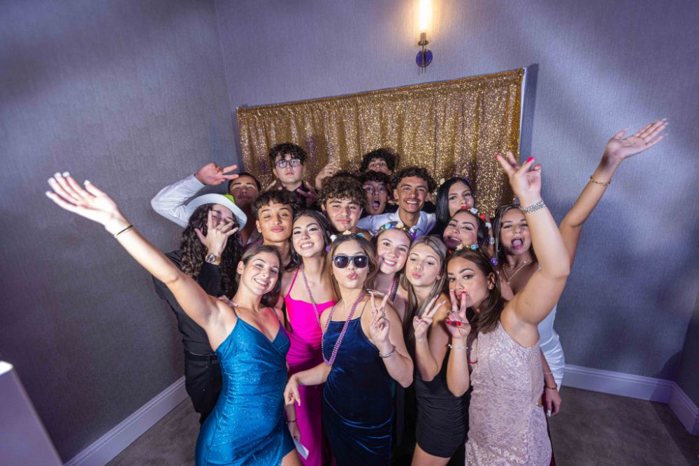 A stylish photobooth setup at a luxury Quinceañera celebration at The Confidante Hotel Miami Beach, planned by a full-se