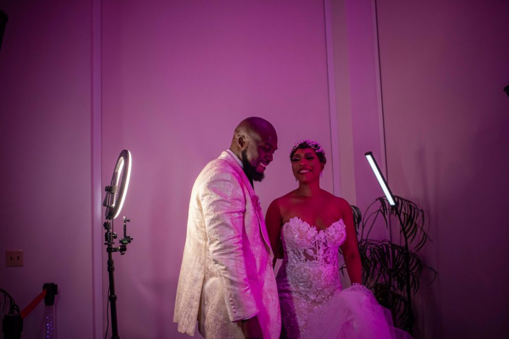 A joyful bride and groom enjoying a 360 Photobooth experience at their luxury wedding, capturing fun and dynamic memorie
