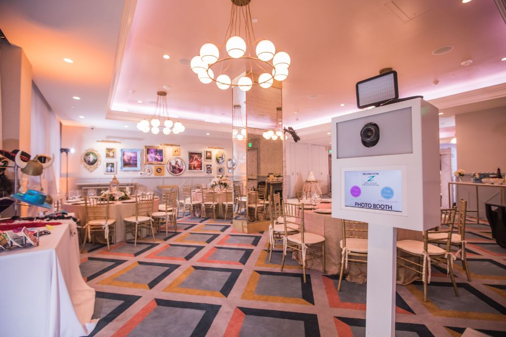 A stylish photobooth setup at a luxury Quinceañera celebration at The Confidante Hotel Miami Beach, planned by a full-se
