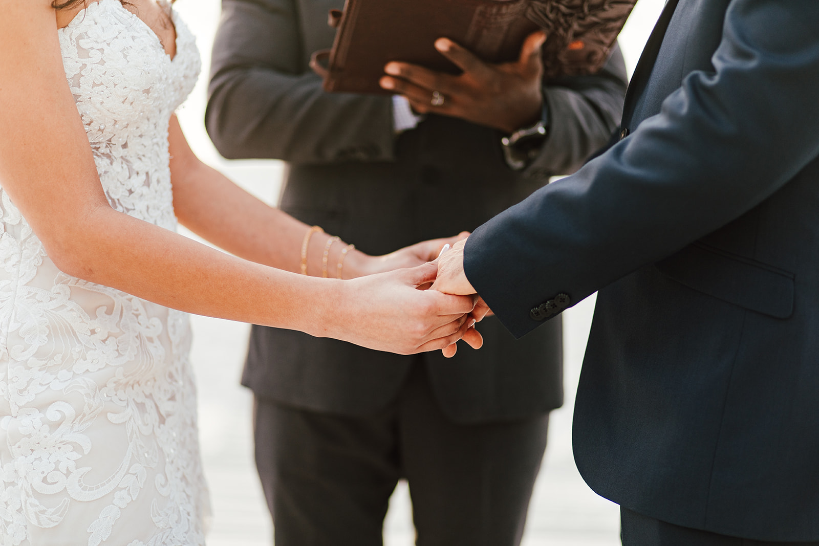 Wedding photo of a couple holding hands.