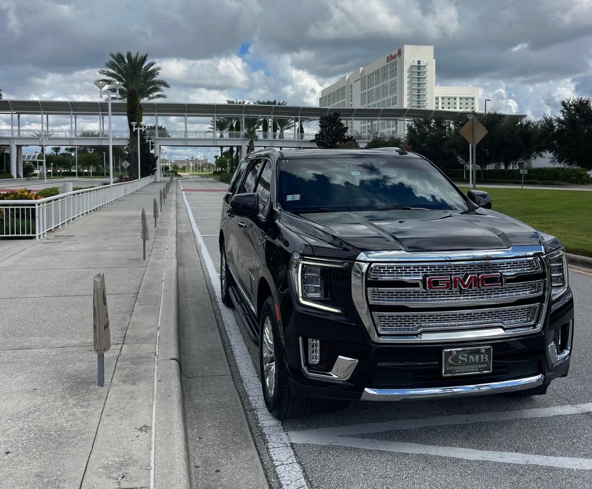 executive suv pickup outside building orlando chauffeur