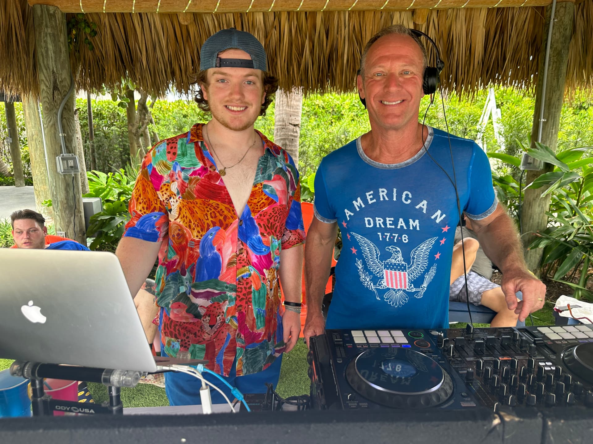 DJ TopJimmy and DJ Dre at a tiki hut DJ booth