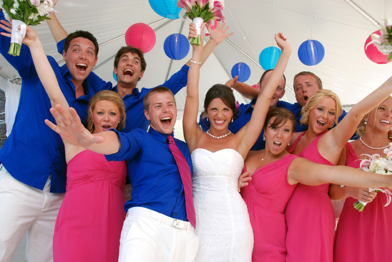 Bride, groom, and wedding party celebrating on the dance floor