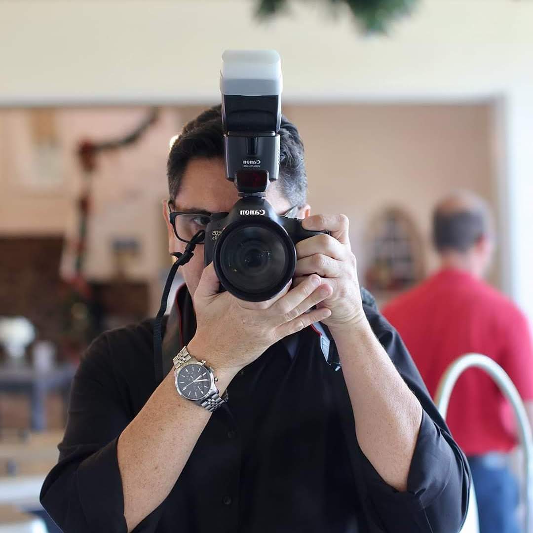 This is an image of Trevor holding his camera up to his face