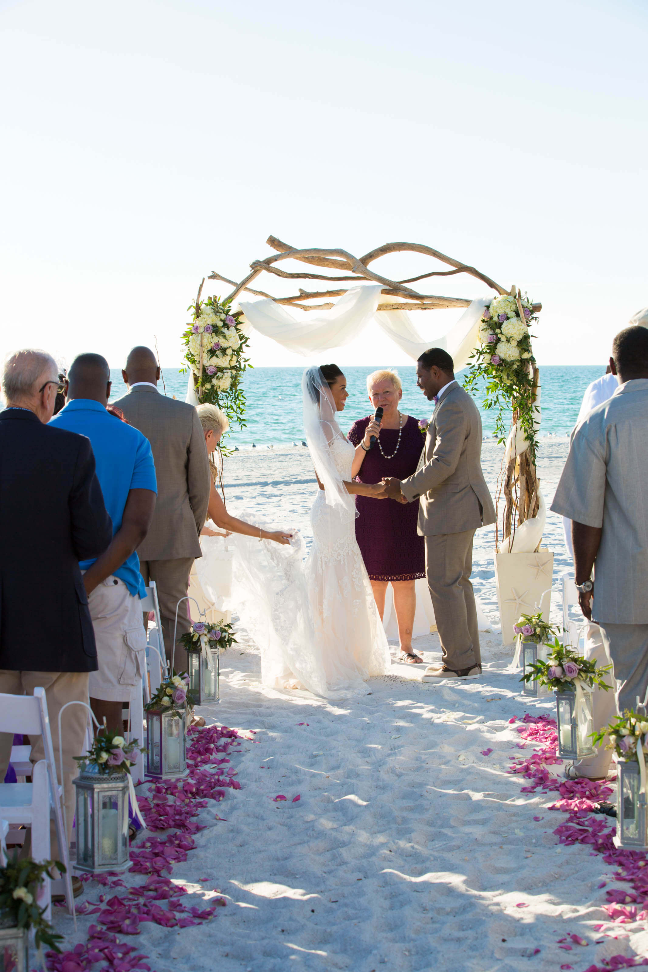 View from the aisle: Eileen (wedding officiant) wearing maroon and the married couple