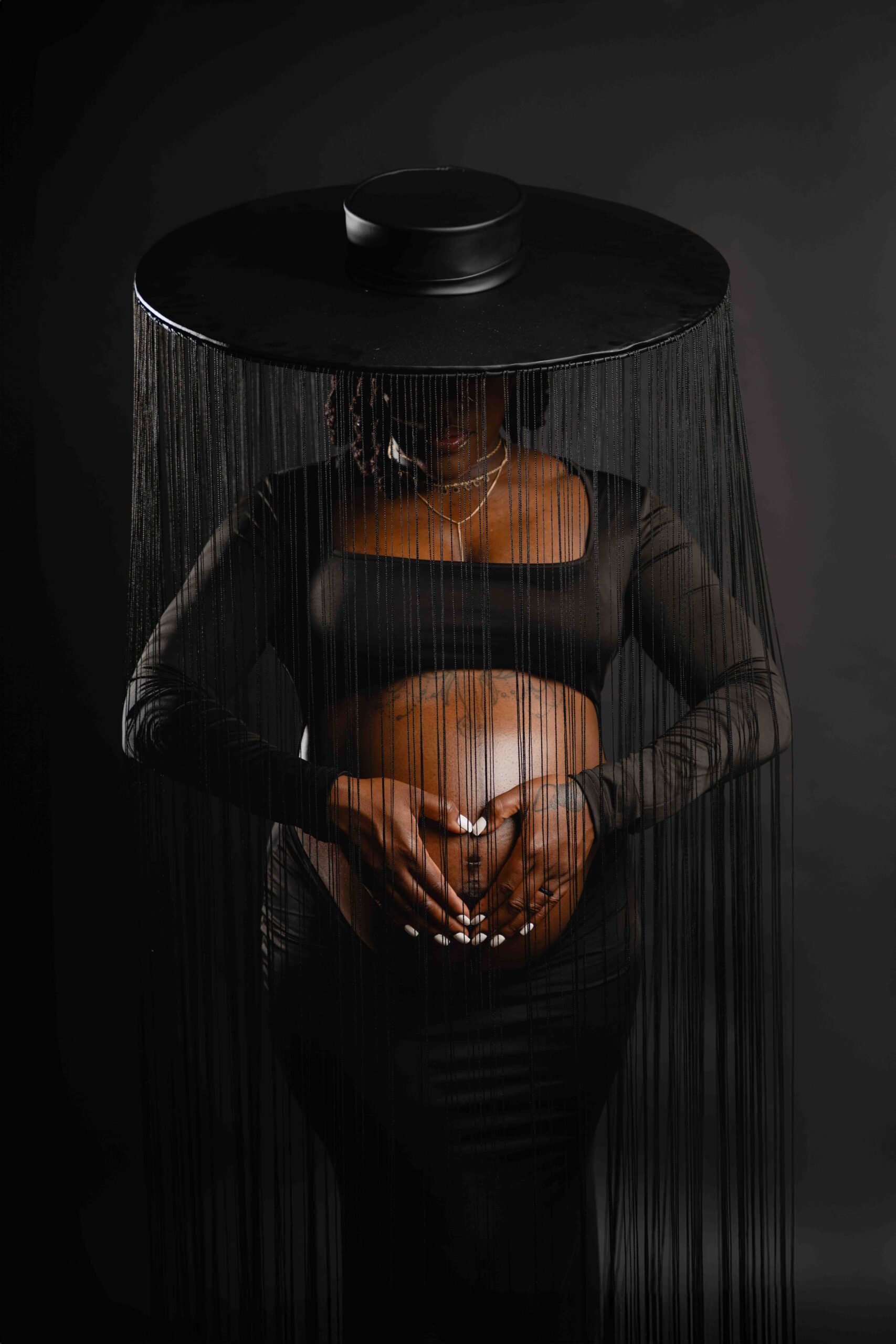 Maternity pregnant woman with black hat and reids editorial photography jacksonville FL