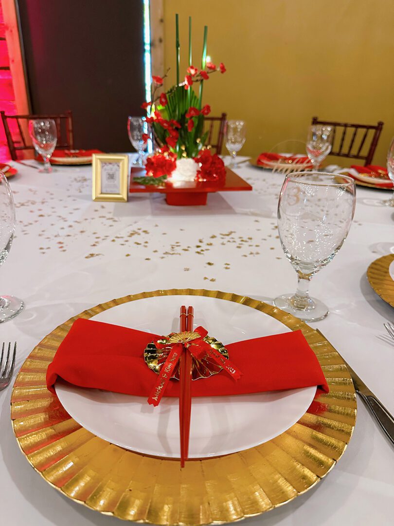 A table set with plates, napkins and silverware.