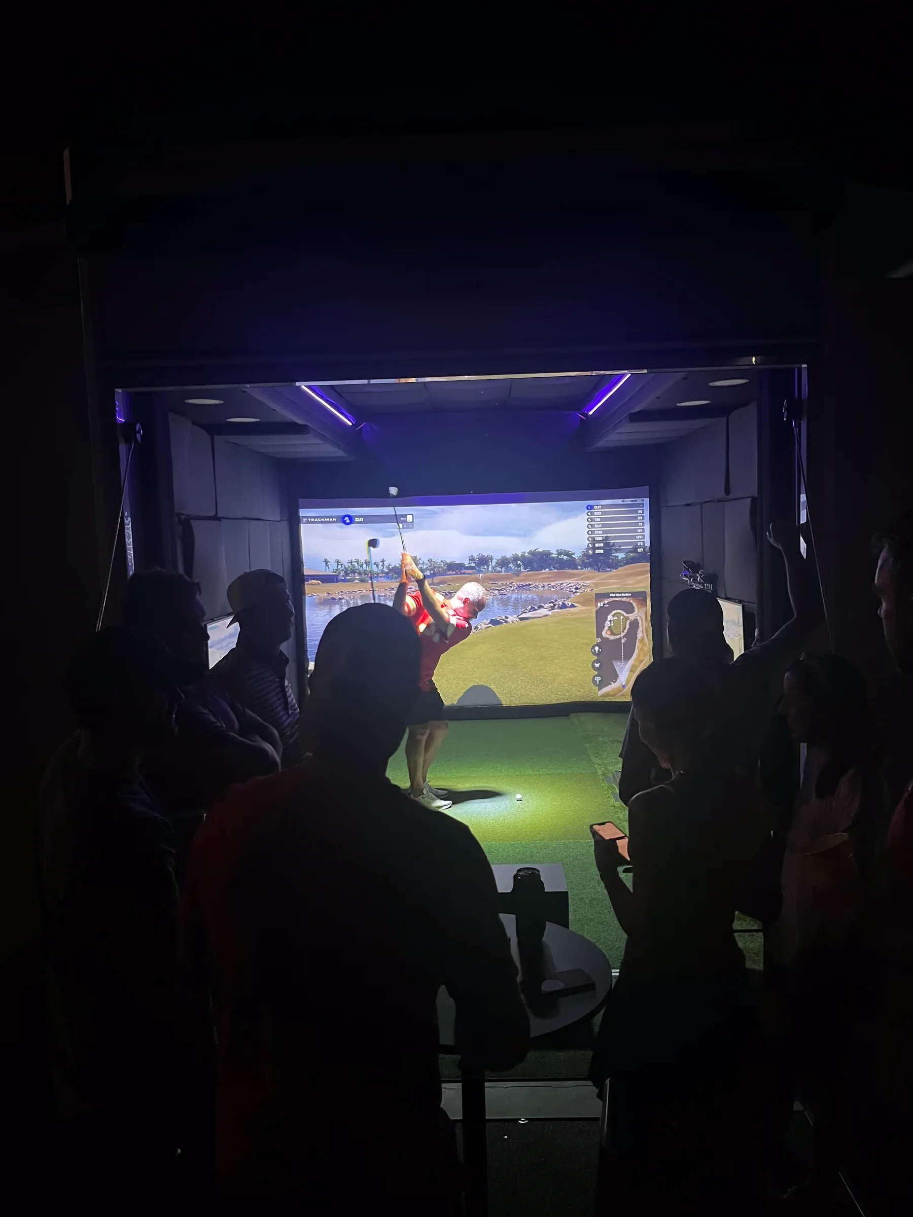 Dryvebox mobile golf simulator interior with a man swinging a club