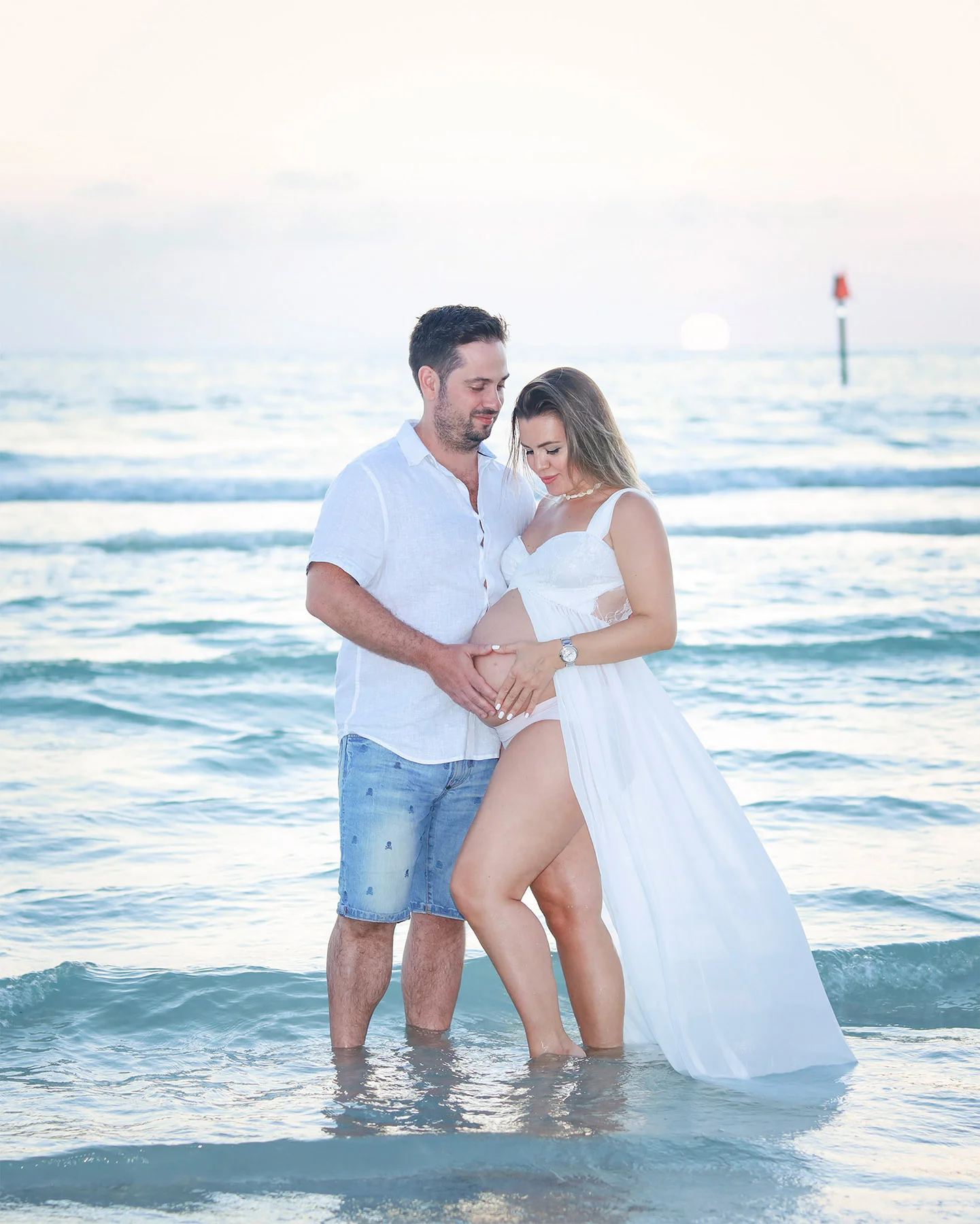 Photo of parent to be on the Naples beach by Katrina Photography