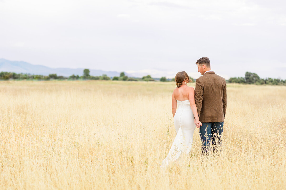 Bride and Groom holding hands in a field for bridal portraits with Beth Kellum Photography