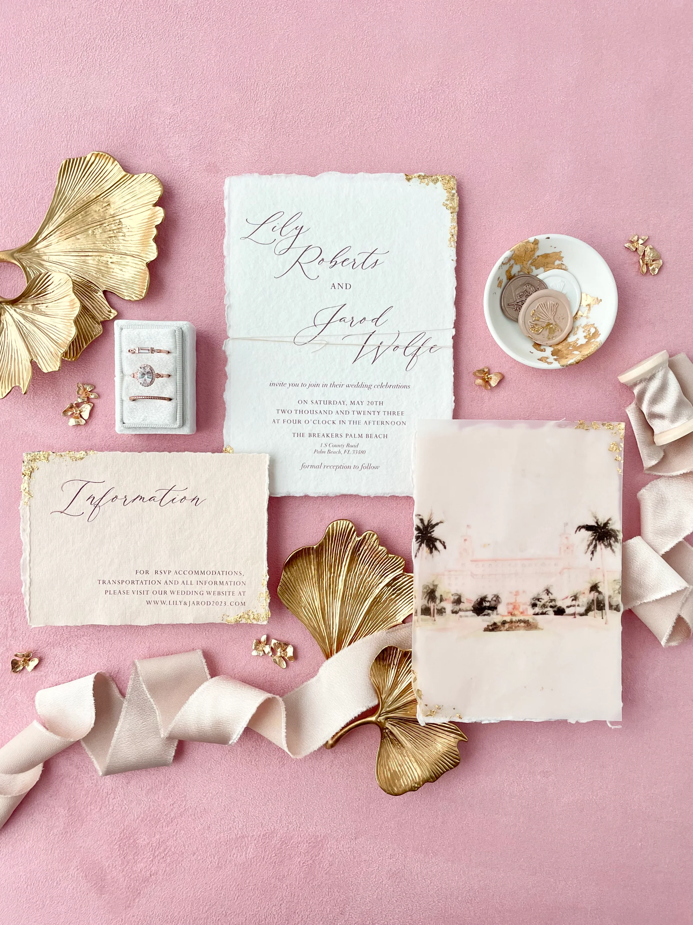 Gold, white and blush flat lay styling kit on a dusty pink styling mat