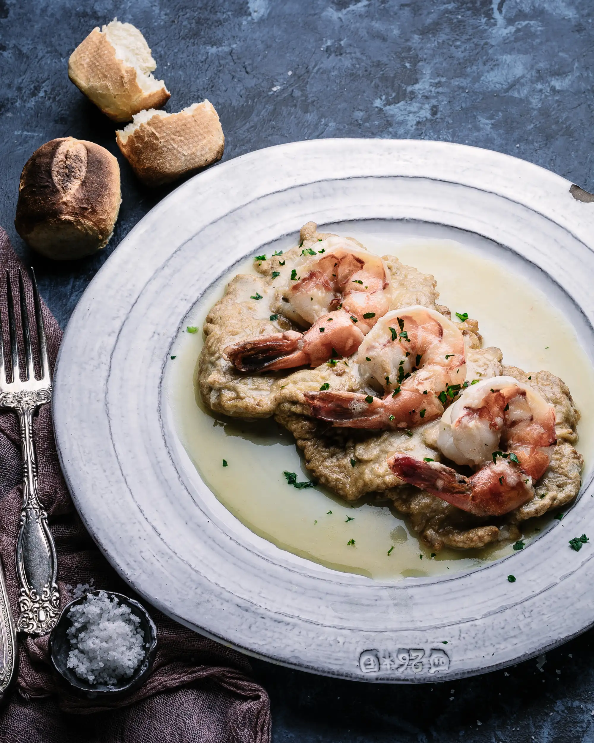Sauteed shrimp over cutlets in a white wine butter sauce