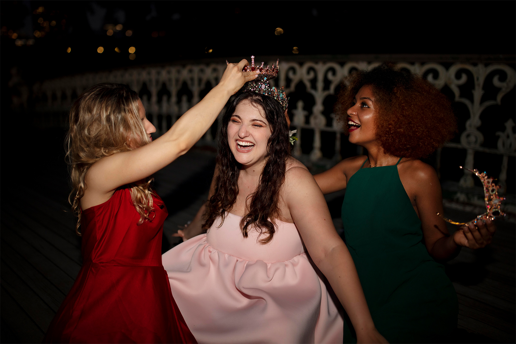 Sweet sixteen crowning moment during an outdoor evening celebration.