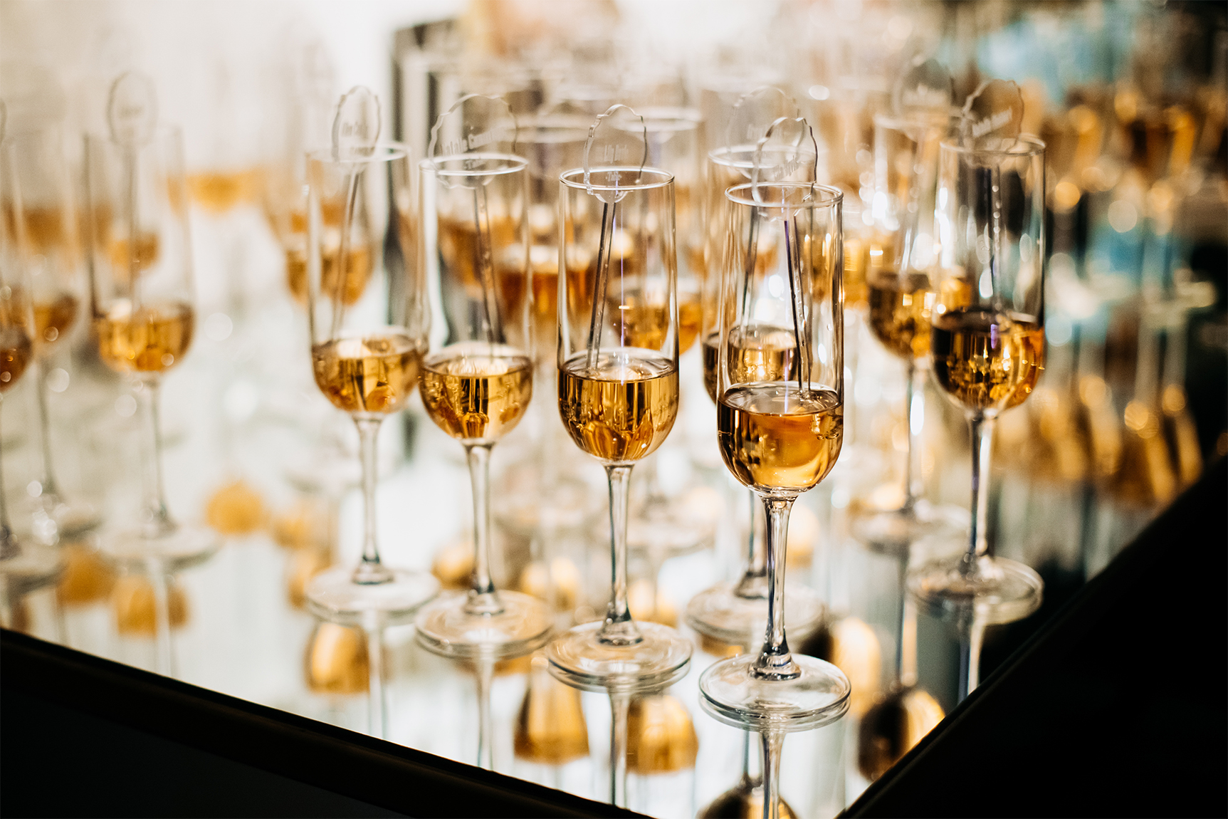 Champagne glasses arranged on a table during an elegant event celebration.