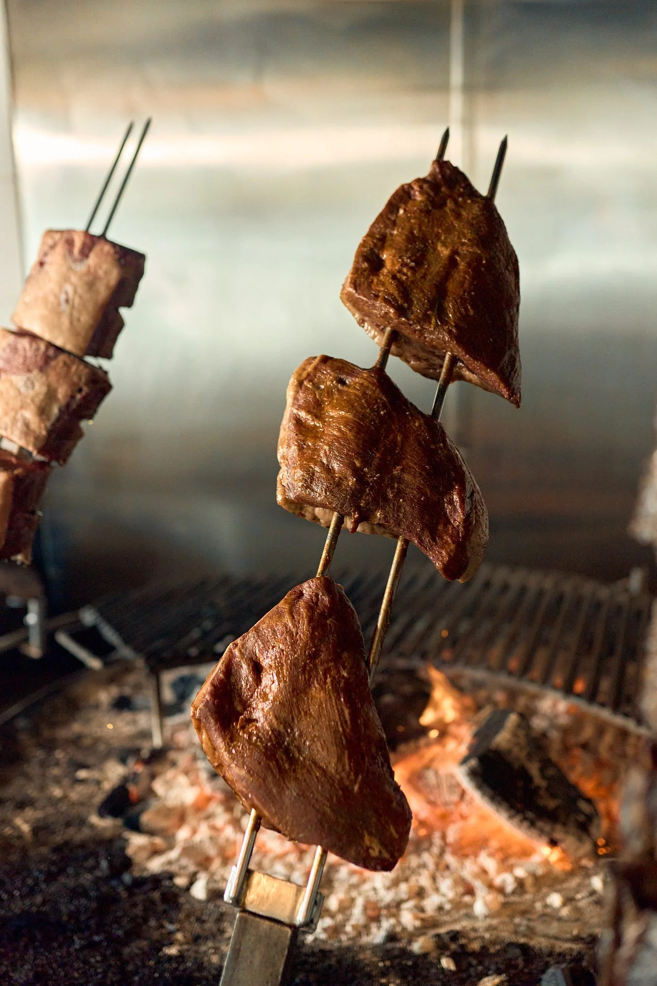 Beef skewer over the coals at the Graziano's asador
