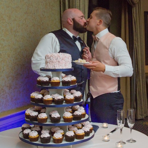 handsome groom and groom with cupcake cake