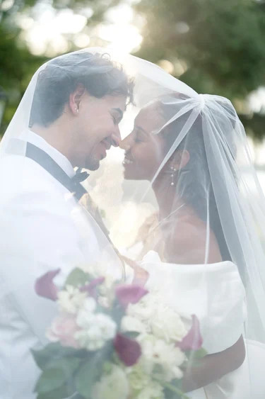 Bride and Groom Share intimate moment under veil in Lakeview Gardens, Umatilla, FL