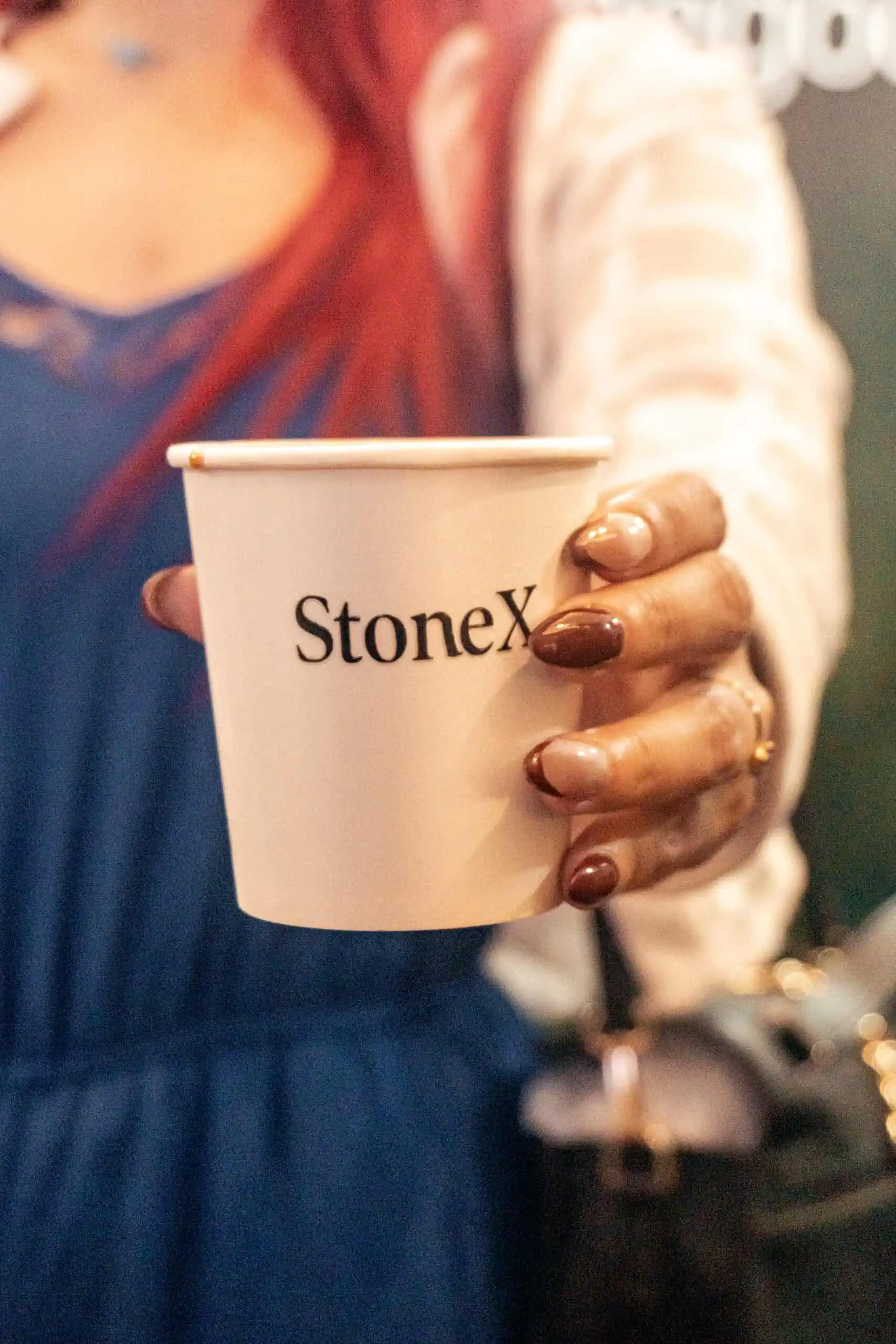 Guest posing with a coffee cup at a coffee catering event