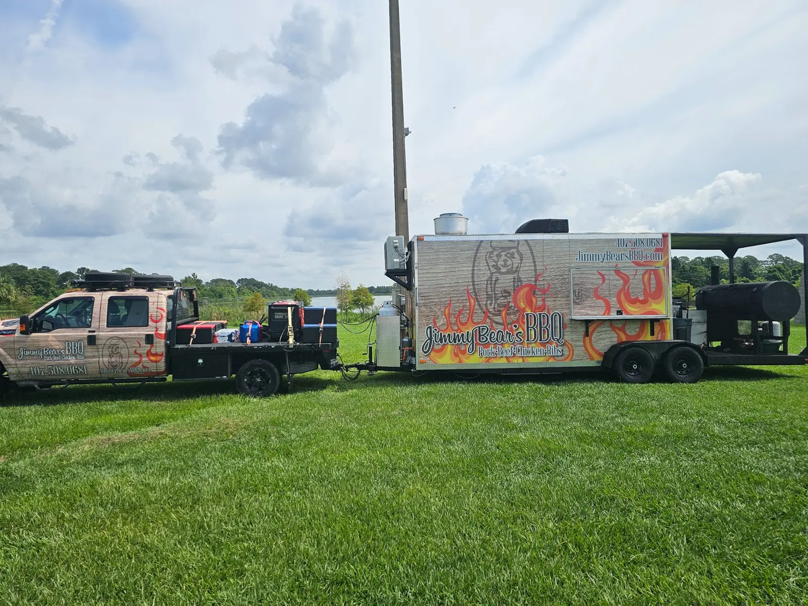 Jimmy Bear's BBQ food truck and large mobile smoker at an outdoor event