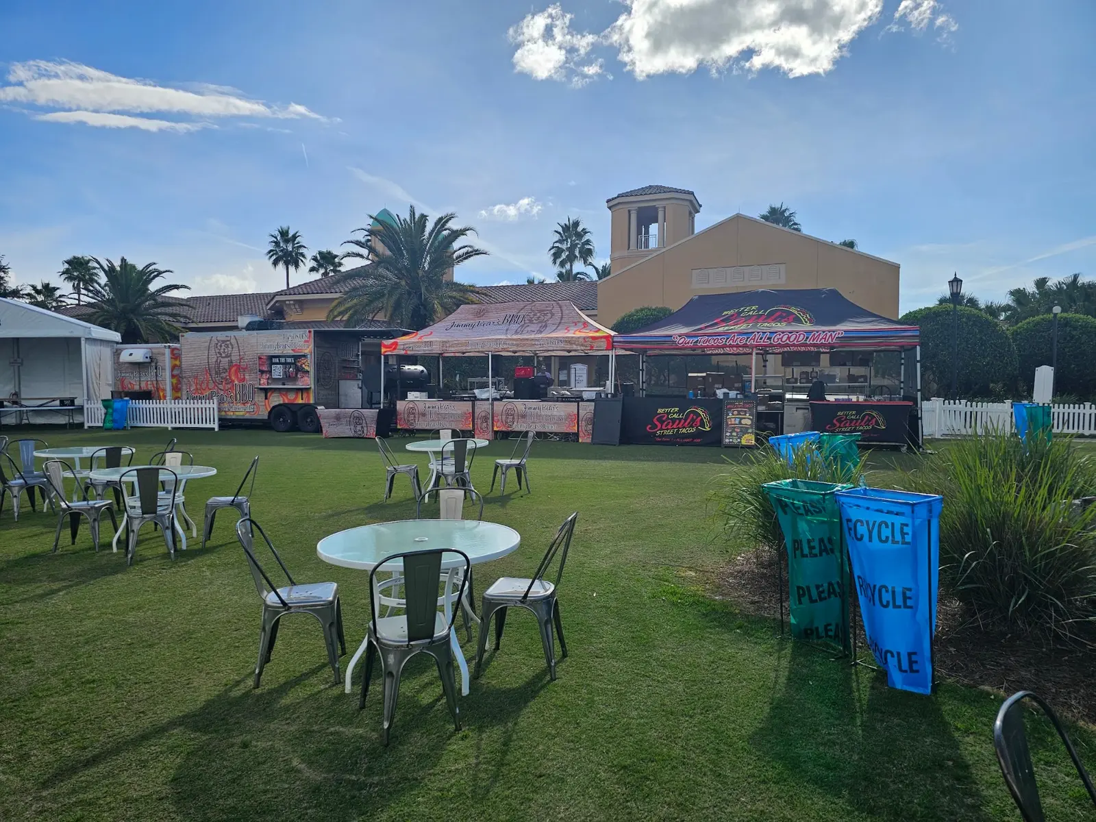 Jimmy Bear's BBQ truck, tents and tables arranged for a lawn event