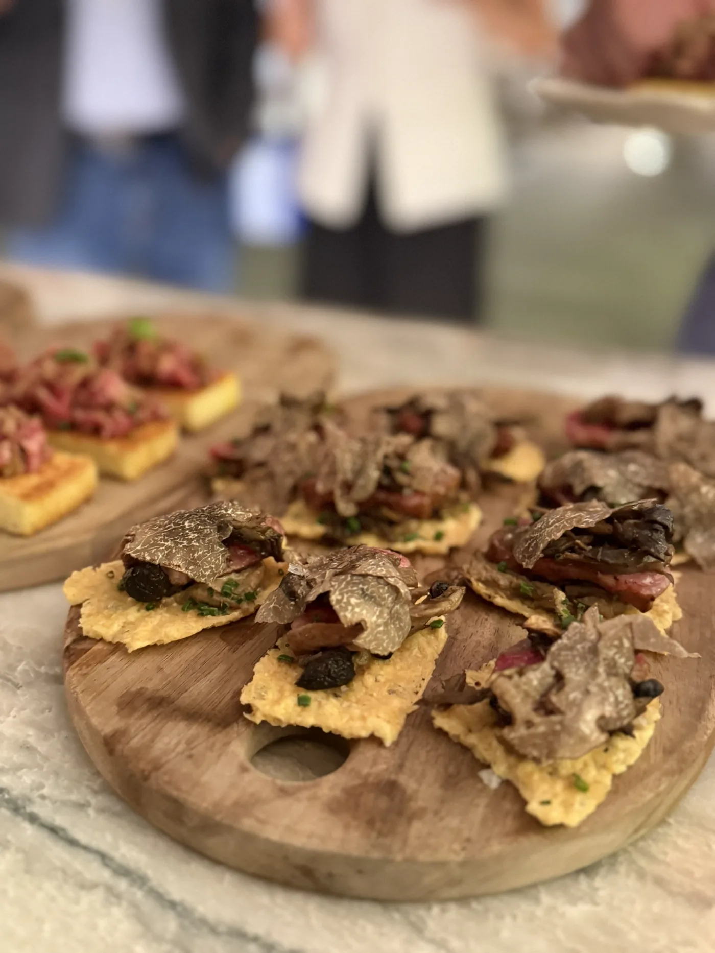 Truffle-topped canapés prepared for a luxury culinary brand event