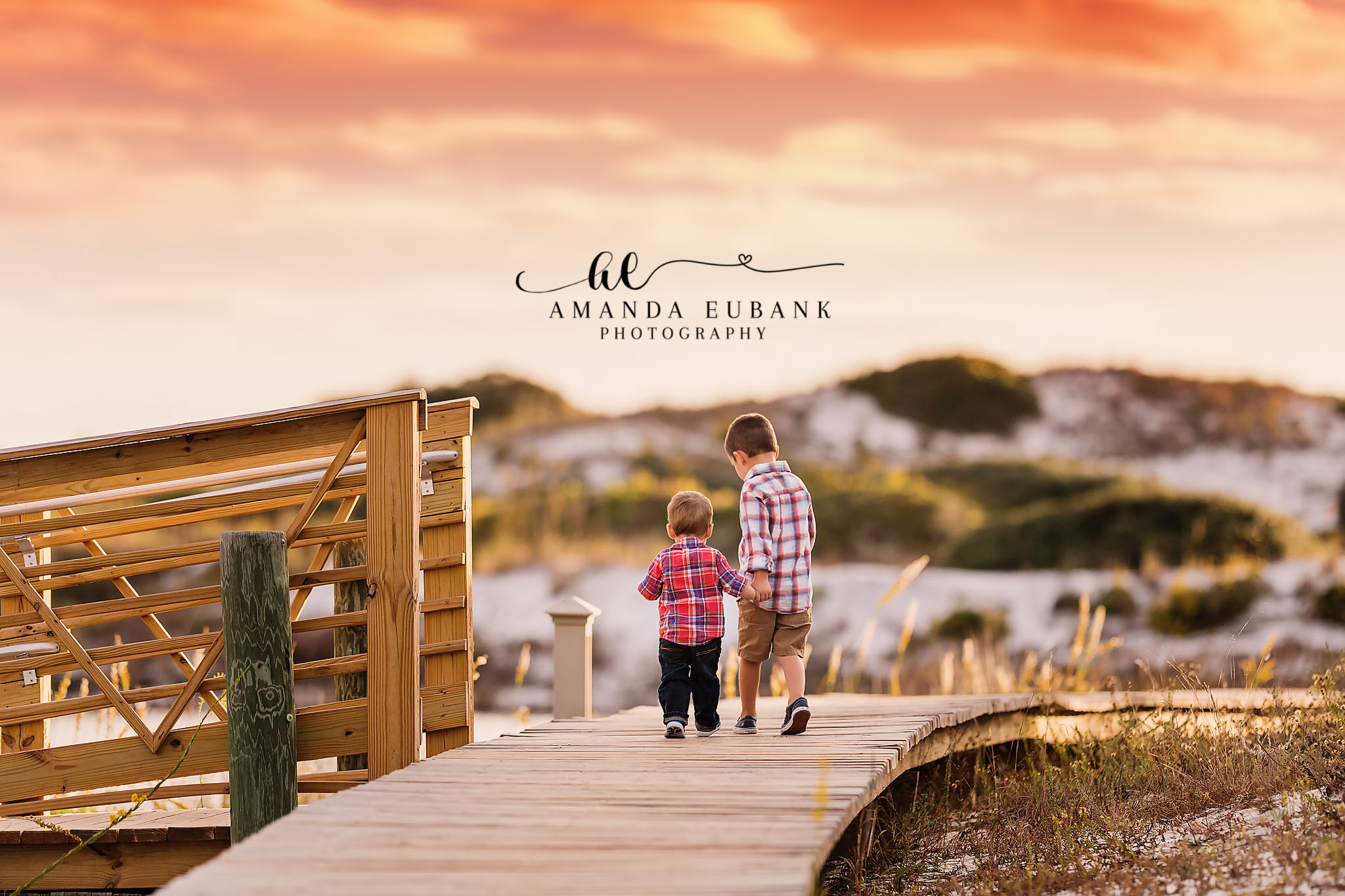 30A family portrait — candid brothers-walking-together boardwalk portrait; photographed by Amanda Eubank Photography alo